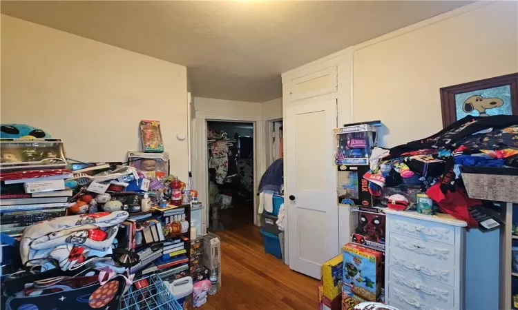 Bedroom with a closet and dark hardwood / wood-style flooring