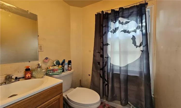 Bathroom with walk in shower, vanity, and toilet