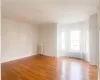 Unfurnished room featuring light hardwood / wood-style floors and radiator heating unit