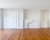 Unfurnished living room featuring wood-type flooring