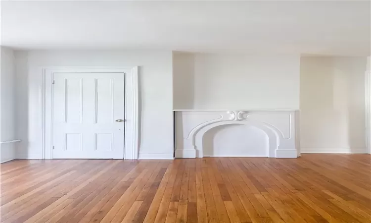 Unfurnished living room featuring wood-type flooring