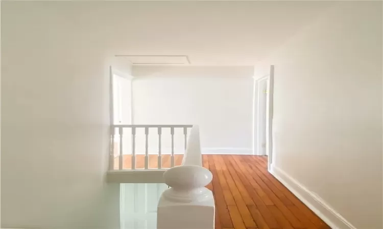 Corridor featuring hardwood / wood-style flooring