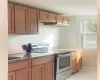 Kitchen with stainless steel electric range oven and sink