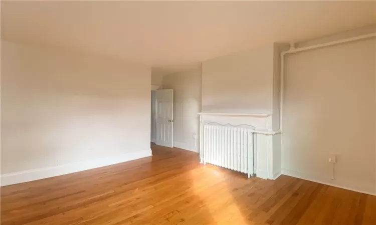 Empty room featuring hardwood / wood-style flooring