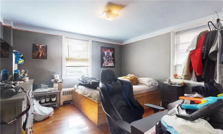 Bedroom 2 unit 2 featuring radiator and light hardwood flooring