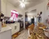 Kitchen with ceiling fan, sink, light hardwood floors, stainless steel gas range, and backsplash