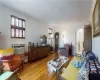 Living room with an AC wall unit and light hardwood flooring