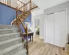 Stairs featuring hardwood / wood-style flooring