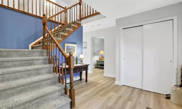 Stairs featuring hardwood / wood-style flooring