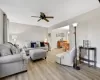 Living room with ceiling fan and light hardwood / wood-style floors