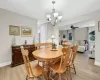 Dining area featuring light hardwood / wood-style flooring and ceiling fan with notable chandelier