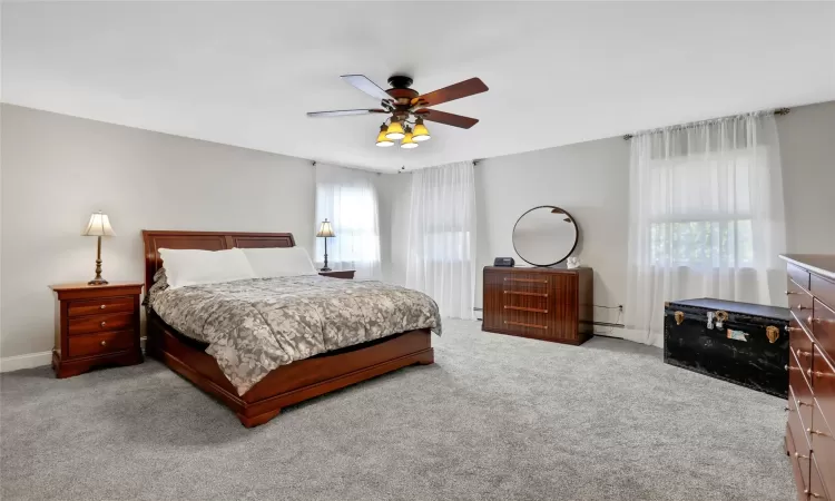 Bedroom featuring ceiling fan and light carpet