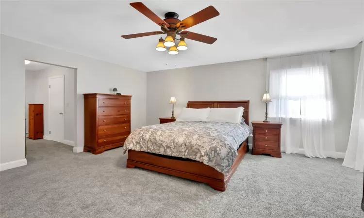 Bedroom featuring ceiling fan and light colored carpet