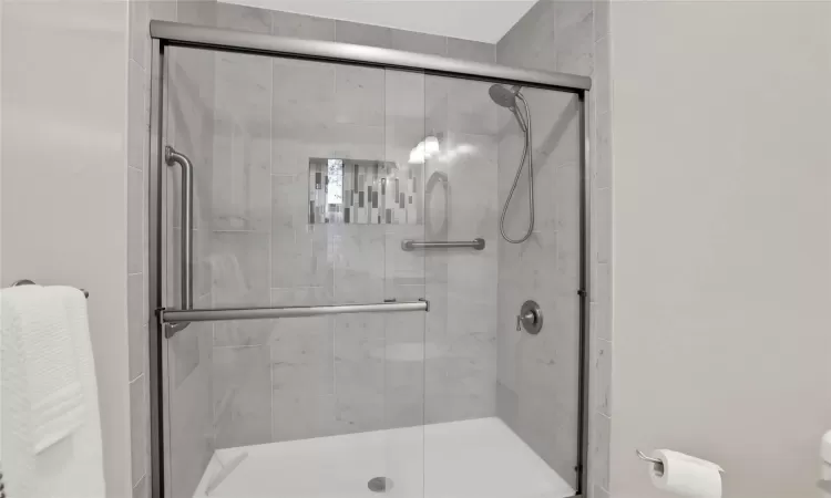 Bathroom with a shower with door