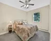 Bedroom featuring carpet flooring, a baseboard radiator, and ceiling fan