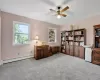 Living area featuring light carpet, a baseboard radiator, and ceiling fan