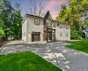 View of front of home with a lawn and a garage. Virtually Enhanced