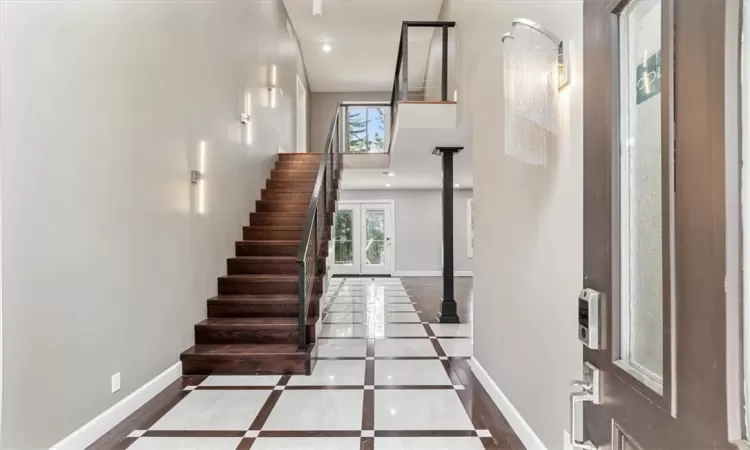 Stairs featuring wood-type flooring and a healthy amount of sunlight