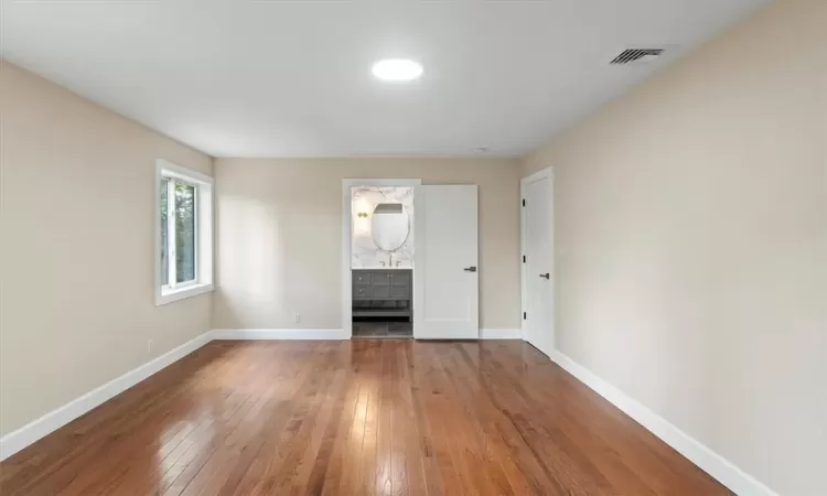 en suite bathroom with standing shower and a huge closet