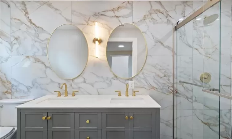 En suite bathroom with standing shower and double vanity