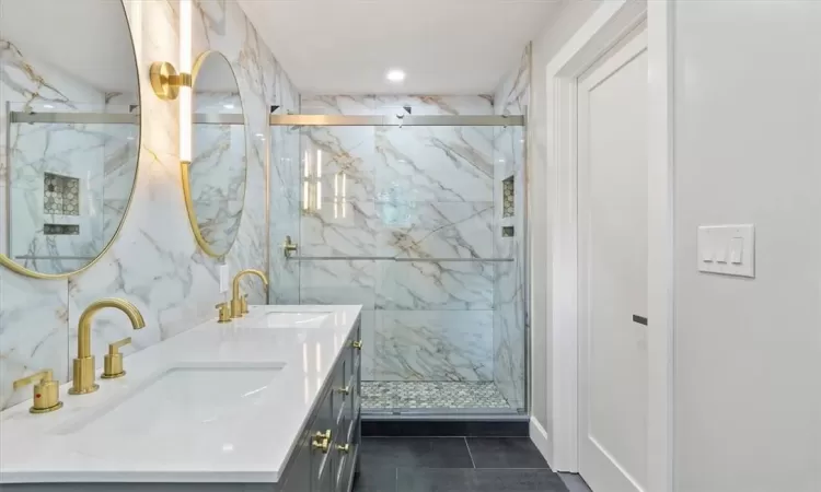 Bathroom featuring vanity, tile patterned flooring, and an enclosed shower