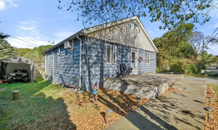 View of side of home featuring a patio area