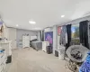 Bedroom featuring light colored carpet and a wall unit AC