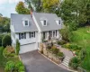 New england style home featuring a garage