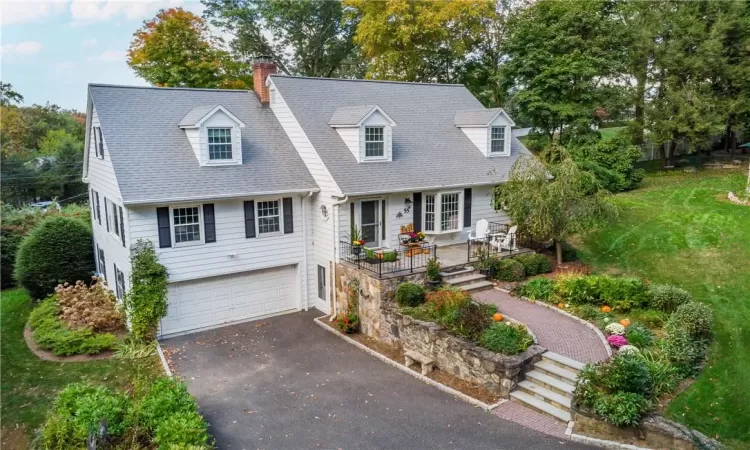 New england style home featuring a garage