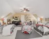 Carpeted bedroom with lofted ceiling and ceiling fan