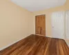 Unfurnished bedroom with dark hardwood / wood-style floors