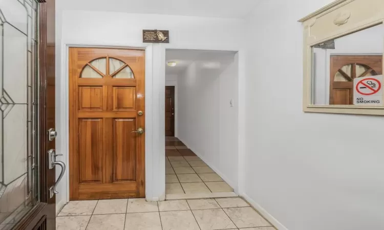 Foyer featuring light tile patterned flooring