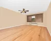 3rd floor living room w/ ceiling fan & hardwood floors