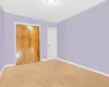 Unfurnished bedroom with a closet and carpet flooring