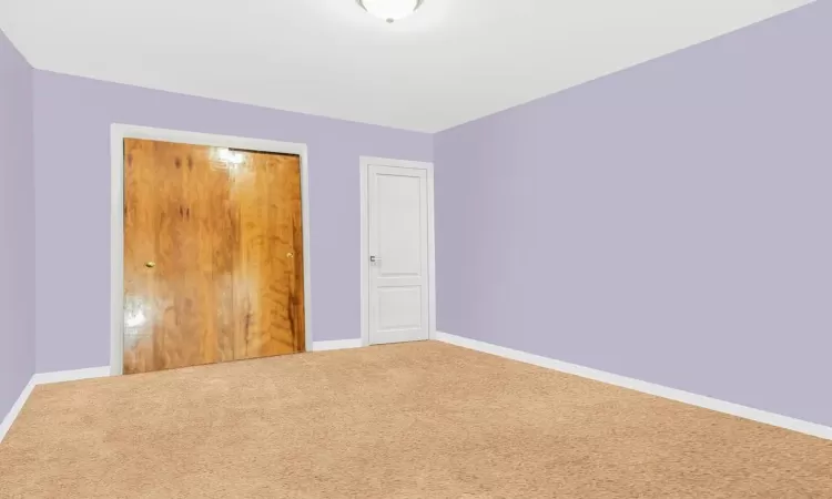 Unfurnished bedroom with a closet and carpet flooring