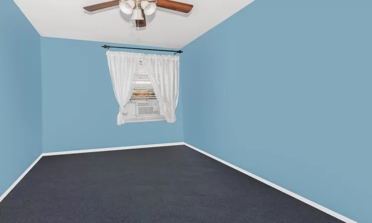 Unfurnished room featuring carpet and ceiling fan