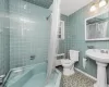 Full bathroom featuring radiator, toilet, shower / bathtub combination with curtain, tile patterned floors, and tile walls