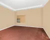 Carpeted spare room with a raised ceiling and cooling unit