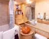 Lower level Full bathroom with vanity, walk in tub/shower combo