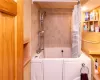 Lower level Full bathroom with vanity, walk in tub/shower combo