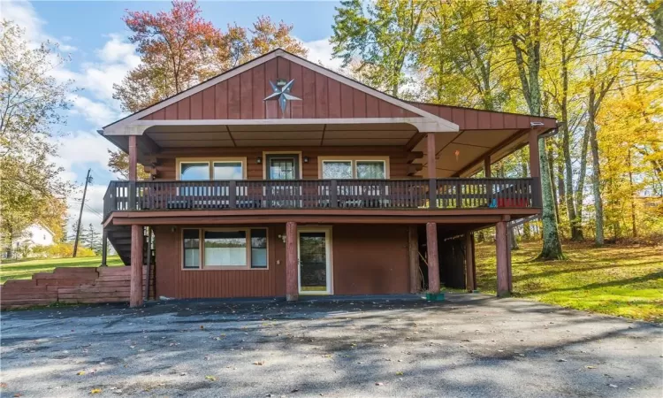 View of front of property with a wooden deck