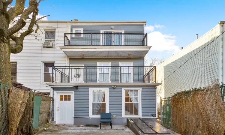 Back of house with a balcony