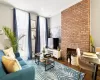 Living room with wood-type flooring and a brick fireplace