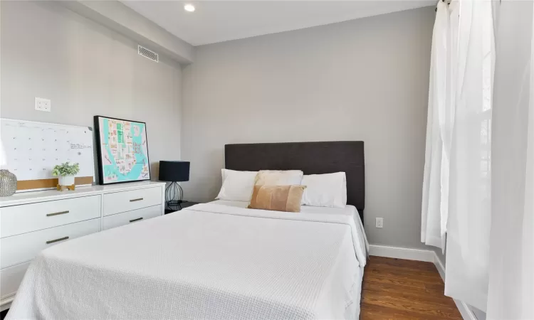 Bedroom featuring dark wood-type flooring