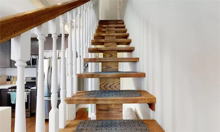 Staircase with hardwood / wood-style flooring