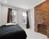 Bedroom with brick wall