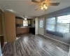 Kitchen featuring electric range, ceiling fan, fridge, dark hardwood / wood-style floors, and sink