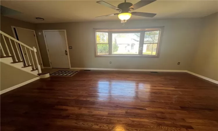 Entrance foyer featuring dark hardwood / wood-style floors and ceiling fan