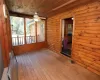 Unfurnished sunroom with ceiling fan and wood ceiling