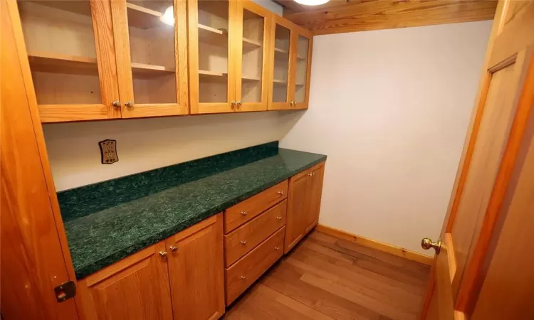 Bar featuring light hardwood / wood-style flooring